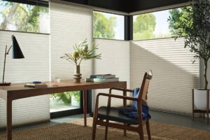 Chic and functional Hunter Douglas energy-efficient window treatments on large windows in a home office at Kerrville Window Fashionsnear Kerrville, TX
