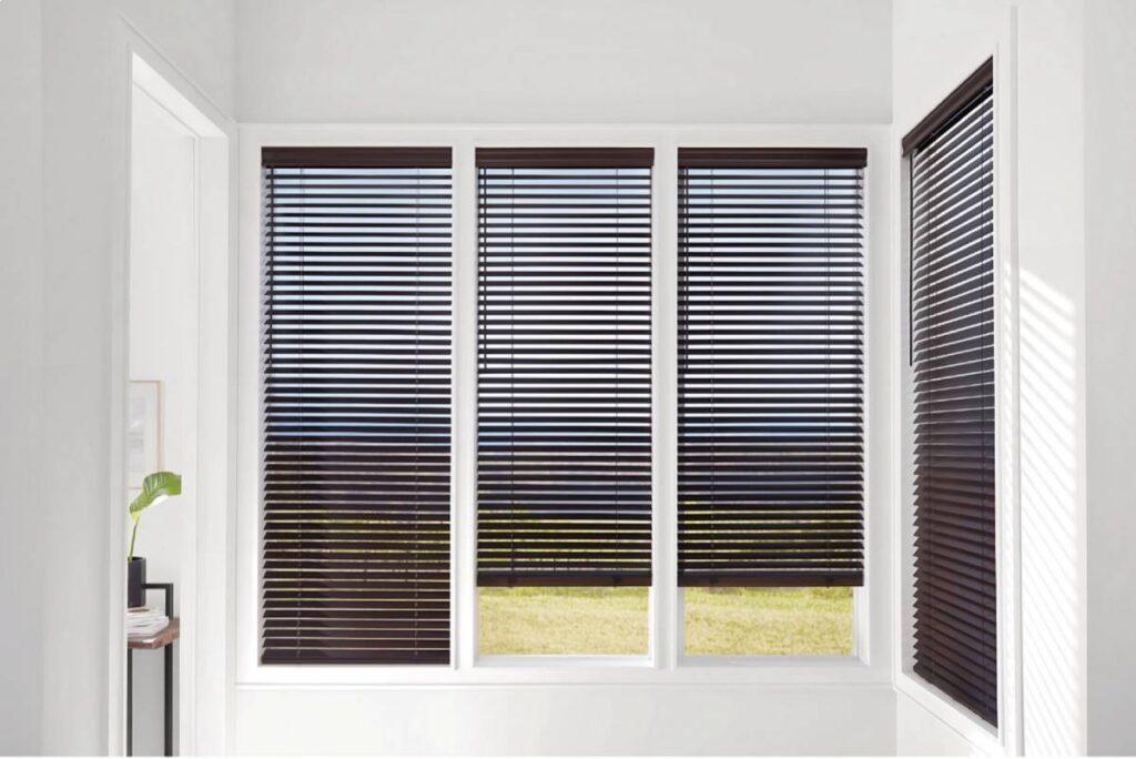 Dark and chic Hunter Douglas wood blinds on four windowpanes in a home’s hallway at Kerrville Window Fashionsnear Kerrville, TX