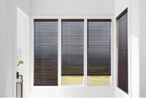 Dark and chic Hunter Douglas wood blinds on four windowpanes in a home’s hallway at Kerrville Window Fashionsnear Kerrville, TX