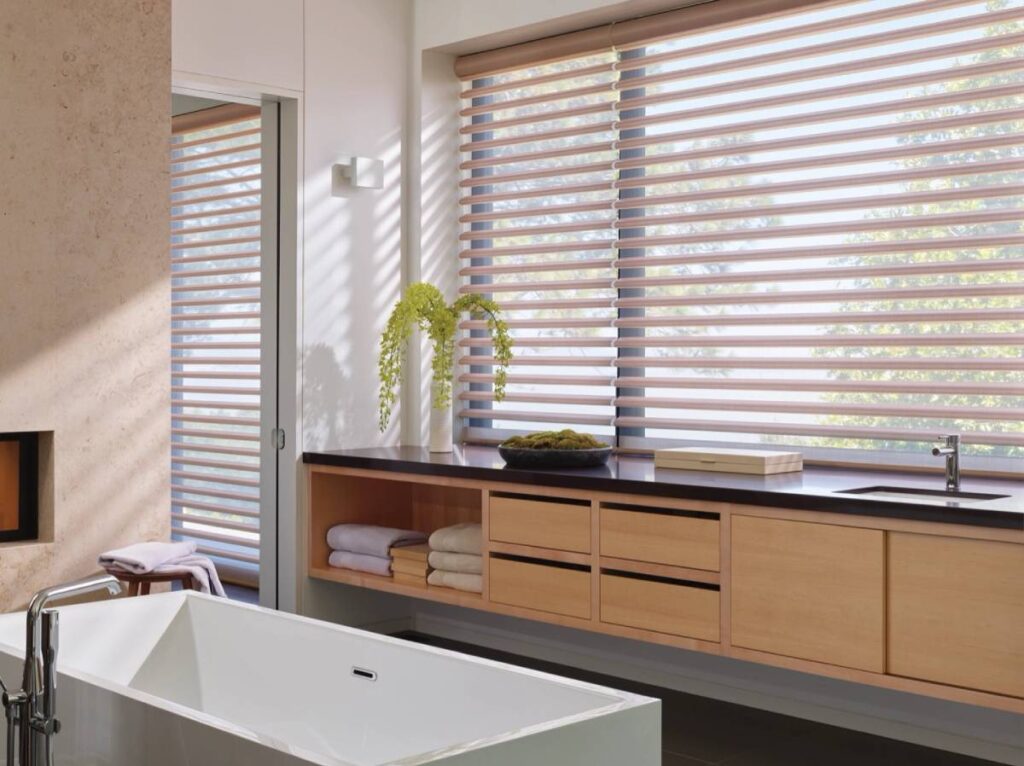 Hunter Douglas Pirouette® Sheer Shades on large windows in a chic and modern bathroom near Kerrville, TX