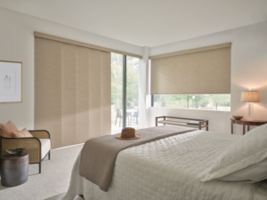 Stylish, reliable, and trendy roller shades on a bedroom window and sliding glass door