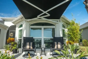 Image of Shade Sense Outdoor awning on the exterior of a home, creating a comfortable patio